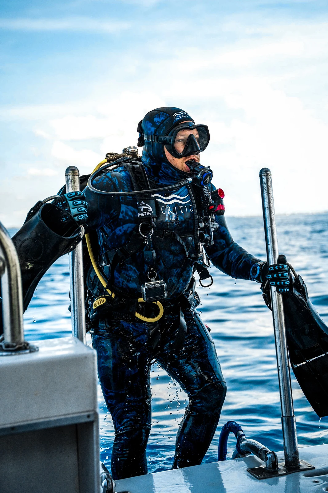 Adam Foglia in full scuba gear aboard the dive boat after a dive